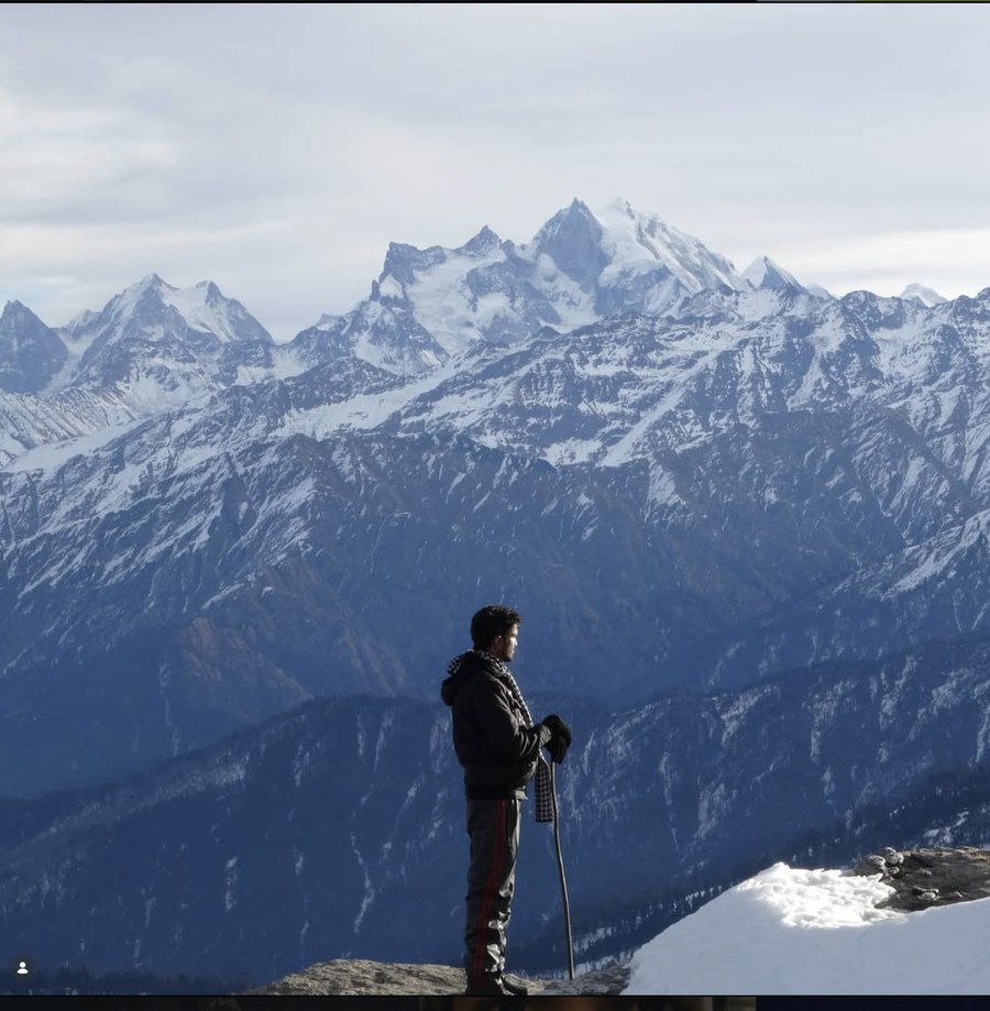 Savan at Kedarkanth peak, snowy Himalayan range behind